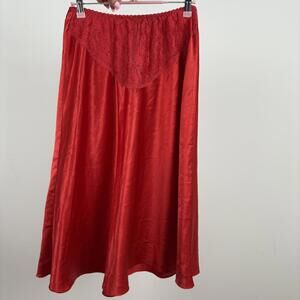 Red satin midi skirt with lace waist trim.